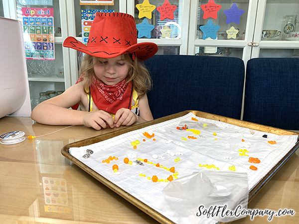 Evelyn Oehler working on jewelry made with the Halloween Mini Design Kit